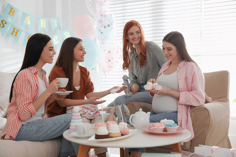 Expectant mother opens gifts at her baby shower